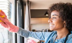 afro-woman-cleaning-window-with-rag-home - illustration