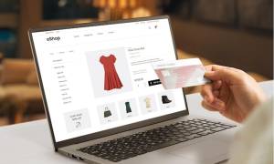 ecommerce web page with woman clothes on laptop display