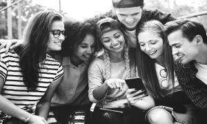 Diverse Group of Young People Happy Looking at Smartphone Image for 5 Unique Career Paths for Millennials and Gen Z in 2022