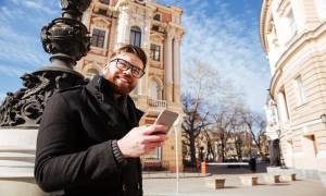 man-coat-street-smartphone-buildings-architecture-museum-tech