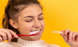 young-woman-brush-teath-oral-health