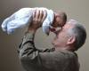 man-lifting-baby-up-happy-older-parent