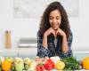 portrait-smiling-woman-looking-vegetables-vegan