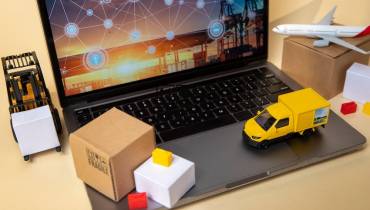 Vehicles on laptop supply chain management representation.