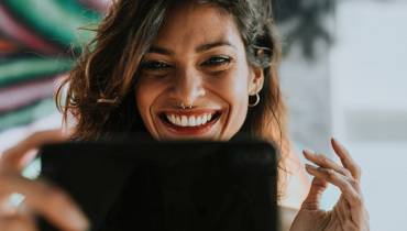 woman-smiling-using-laptop-apps-for-creative-pro
