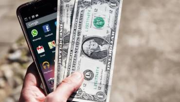 Smartphone and Dollar Bills Image for App Monetization Trends You Should Not Ignore