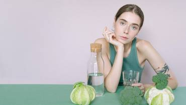female-vegan-dietary-supplements-vegies-water-on-table