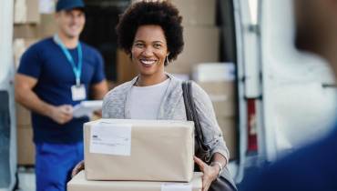 happy-african-american-woman-holding-delivered-packages-couriers-is-standing-background