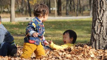 happy-kids-playing-autumn-nature - How Nature Impacts Children’s Well-Being Illustration