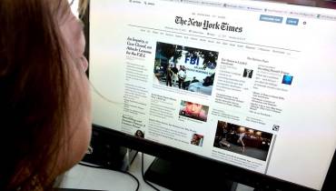 person-using-desktop-computer-reading-news-on-internet-source-of-news