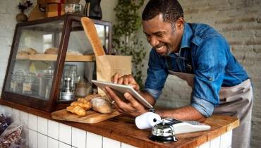 man-small-business-owner-using-digital-tablet-ai-adoption-boost-efficiency