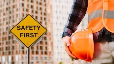 safety-first-sign-man-holding-helmet