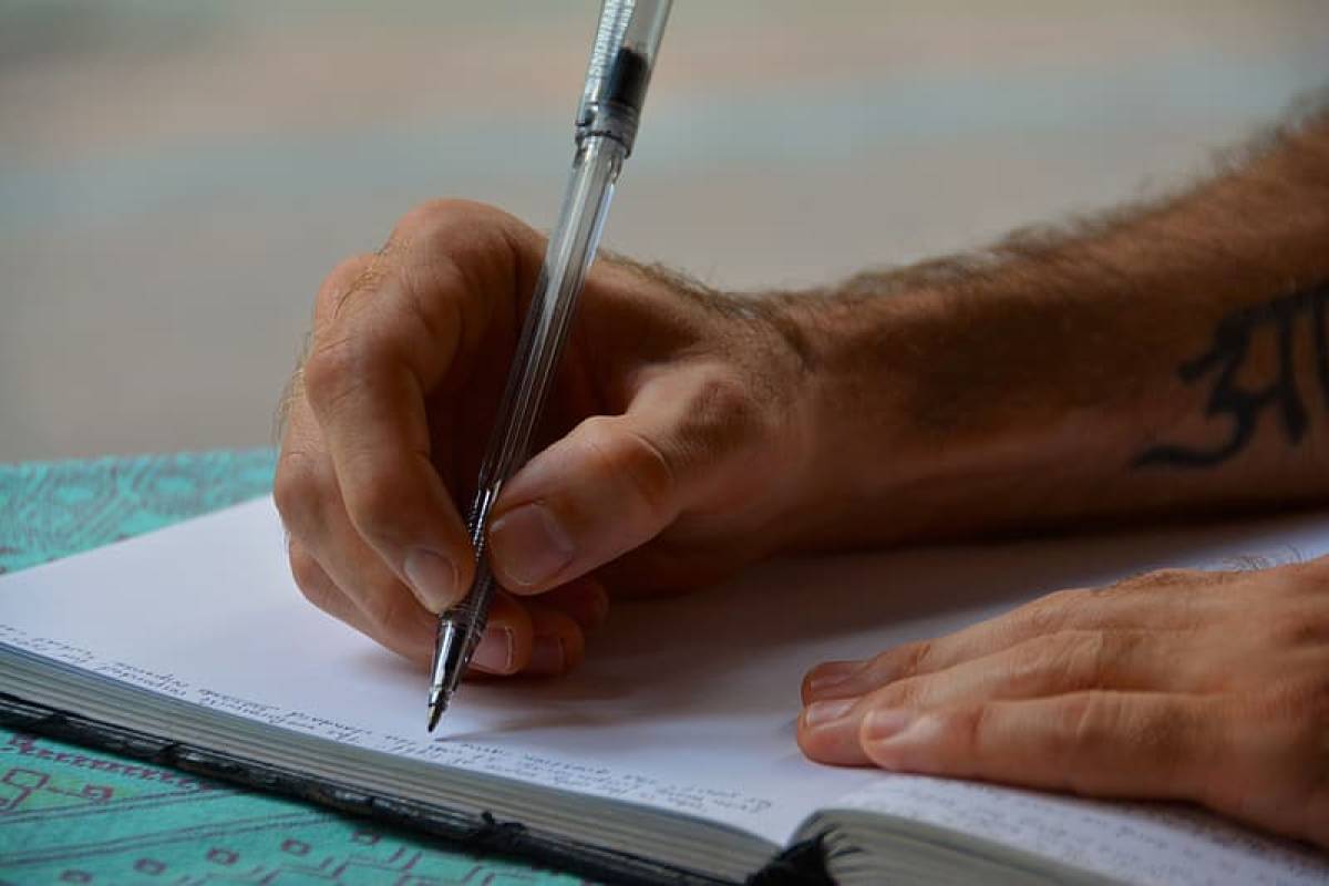 person-holding-pen-on-white-book-page-handwriting-unique-as-fingerprint