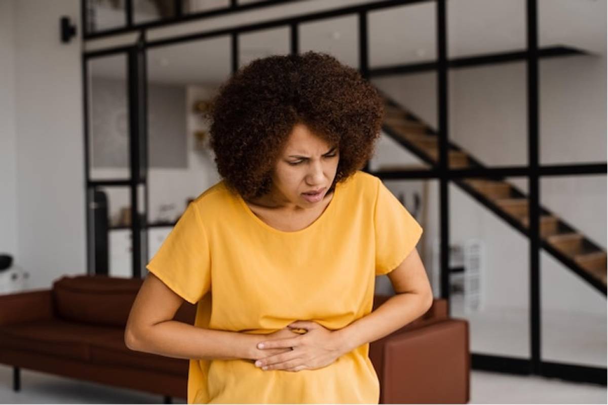 woman holding abdomen stomack upset and bloating