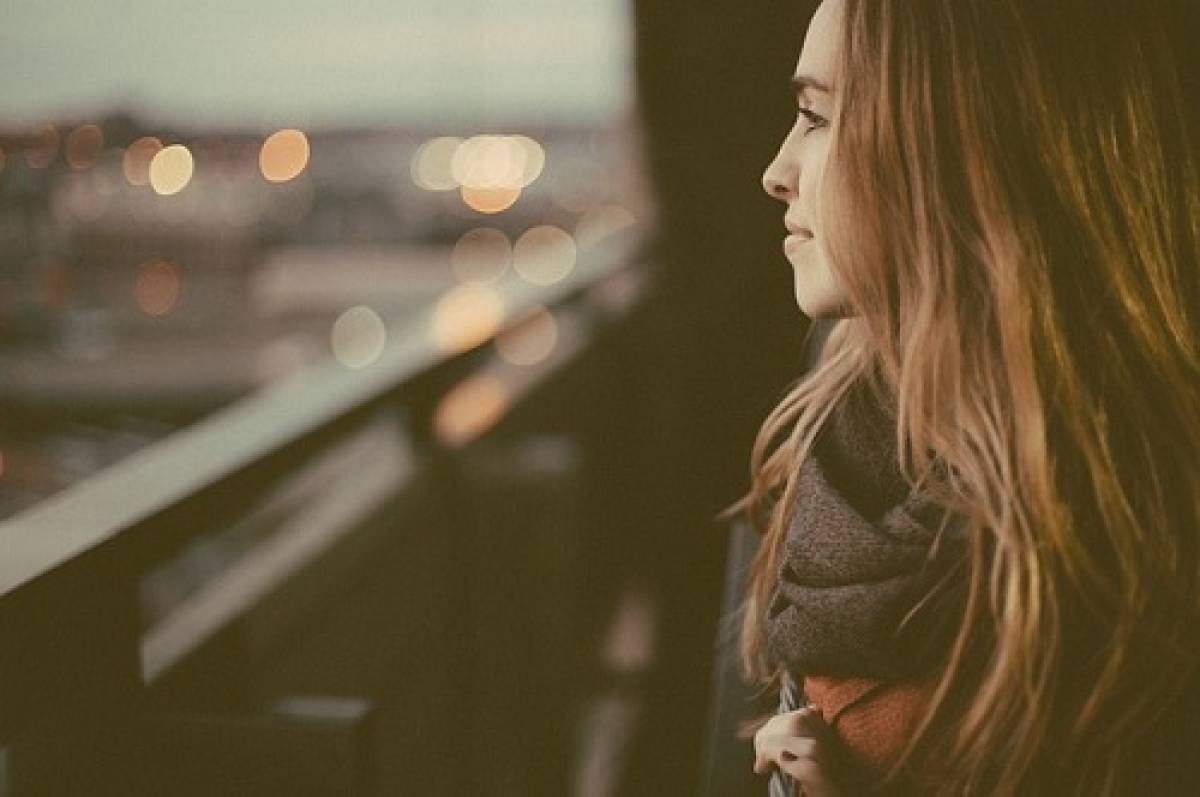 woman-gazing-through-window-pane