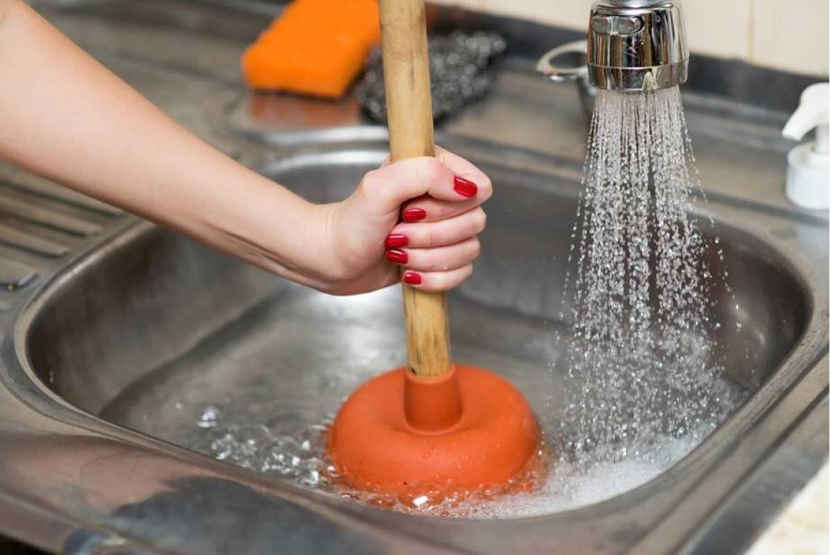 woman-hand-pump-kitchen-sink