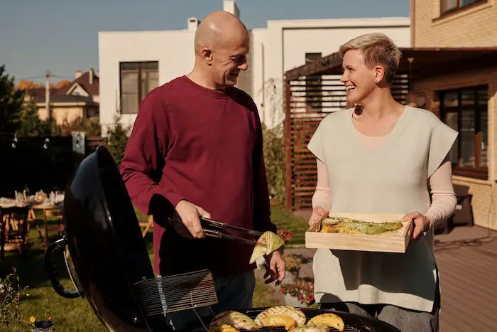 bbq-man-woman-laughing-serving-together.jpeg