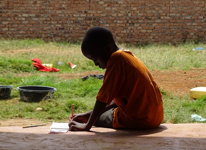 boy_sitting_on_the_porch_in_kampala.jpg