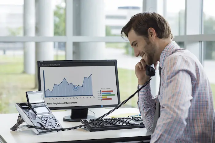 businessman-talking-telephone-office-cloud-communication-ucaas-strategy.jpg