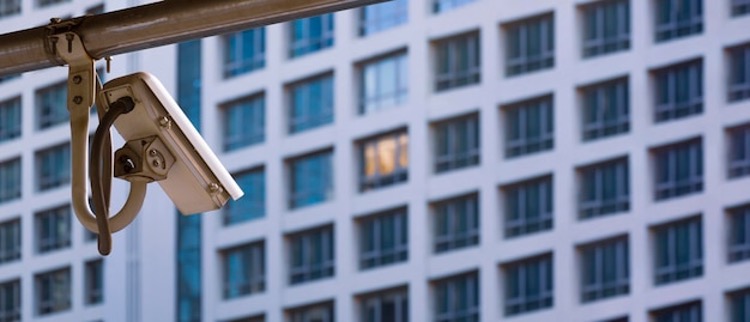 cctv_surveillance_camera_with_blurred_apartment_building_background.jpg