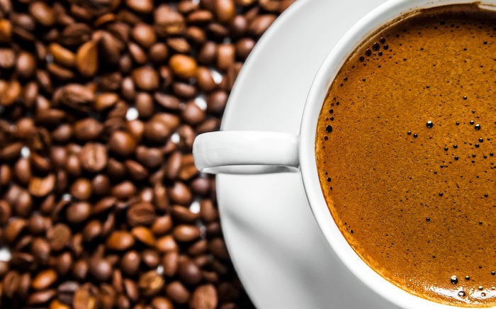 coffee-cup-coffee-beans-on-table-top