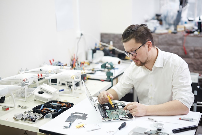 computer-technician-disassembling-laptop-14892.jpg