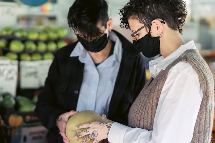 concentrated_women_choosing_melon_in_local_vegan_bazaar.jpg