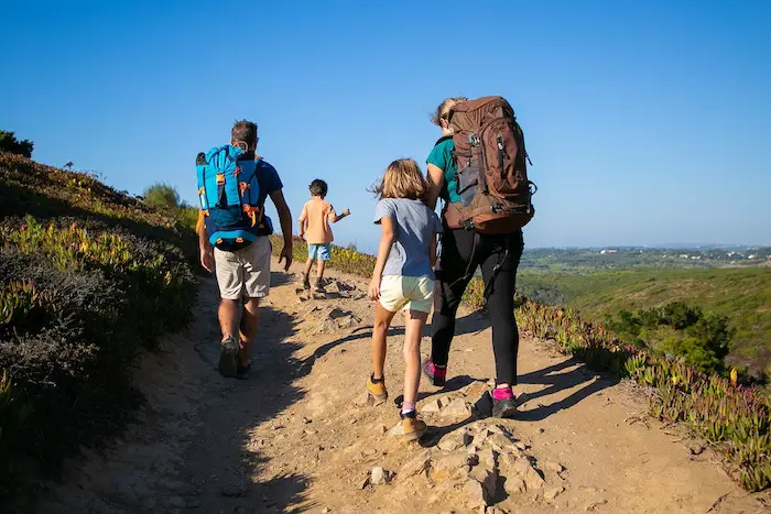 family-travelers-with-backpacks-walking-track-parents-two-kids-hiking-outdoors-back-view-active-lifestyle-adventure-tourism-concept_74855-11685_0.jpg