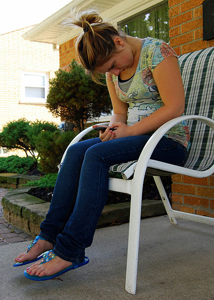 female_teen_sitting_texting.jpg