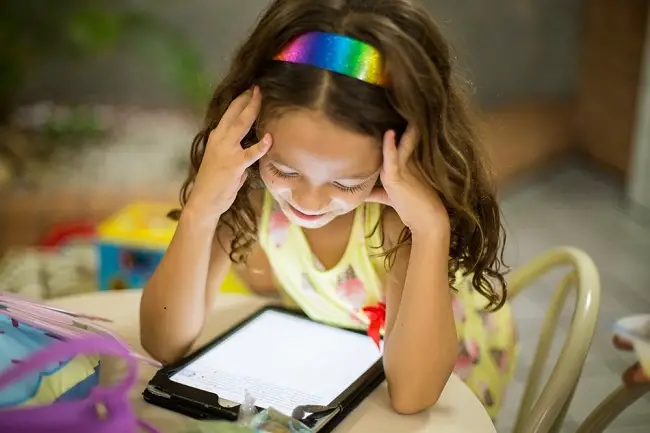 little-girl-reading-from-tablet-using-different-reading-tools.jpg