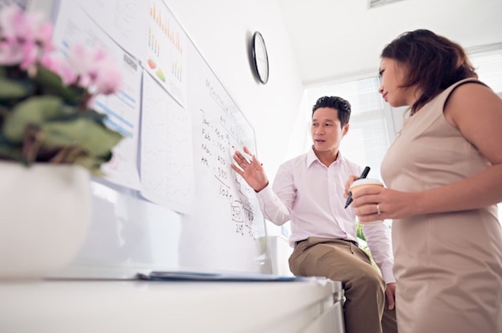 man-woman-in-tech-working-whiteboard