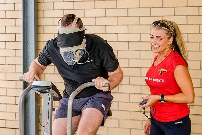 man-workingout-teadmill-wearing-mask-personal-trainer.jpg