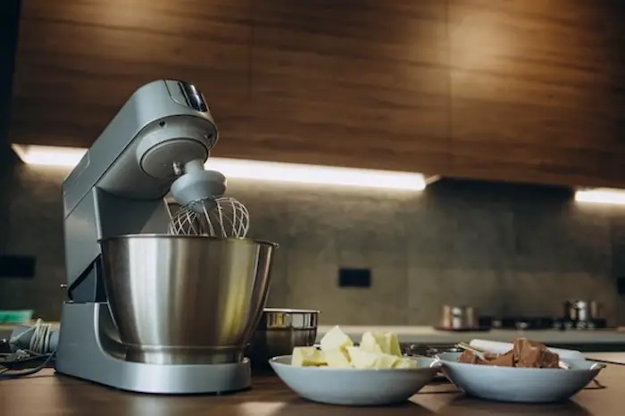 mixer_with_a_metal_cup_stands_in_the_modern_kitchen.jpg