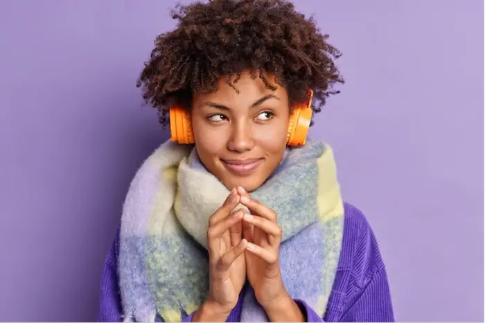 woman-afro-coy-smile-wearing-headset.png