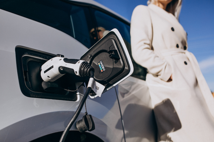 woman-charging-electro-car-by-her-house