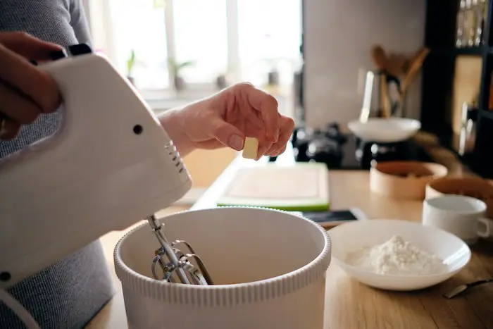 woman-hands-using-white-handheld-mixer.jpg