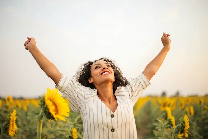 woman-outdoors-arms-up-happy-grateful