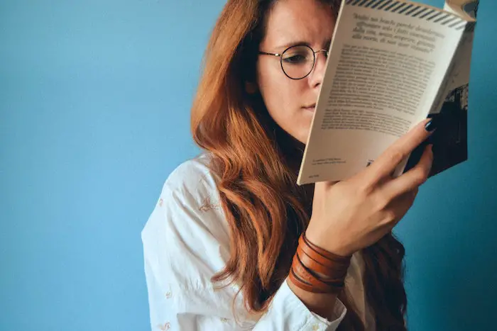 woman-reading-book-blue-background.jpg