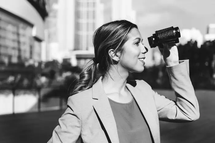 woman-smiling-looking-into-binocular-job-hunting.jpg