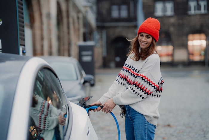 woman-smiling-recharging-electriv-car.jpg