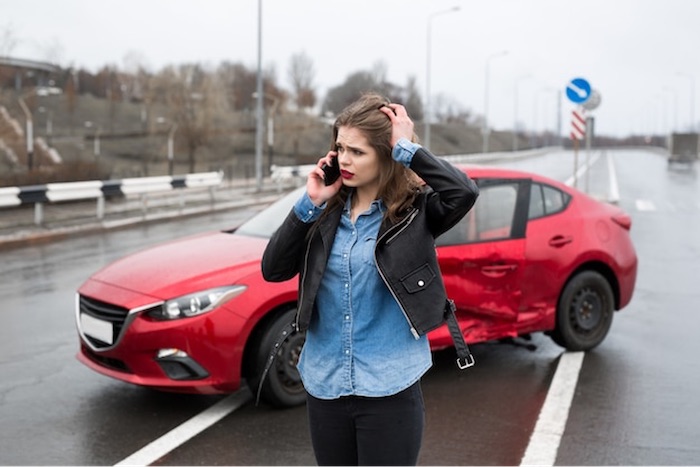 woman-standing-next-to-red-car-crush.jpeg