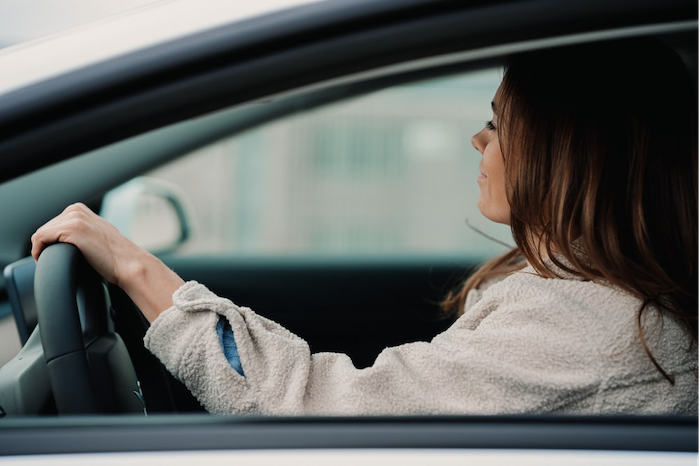 woman-steering-wheel-driving-car.png