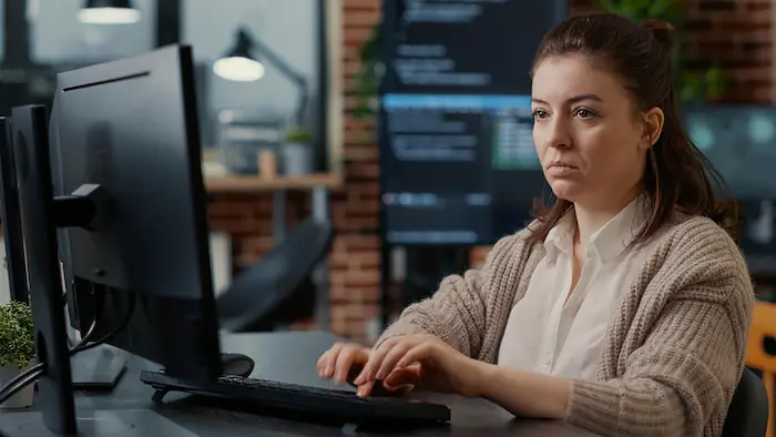 woman-working-focused-looking-computer-screen-while-typing-office.jpg