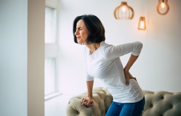 woman_holding_her_lower_back_suffering_back_pain