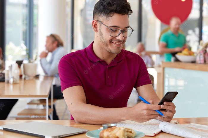 young-male-freelancer-holds-cell-phone-holding-pen-set_goals