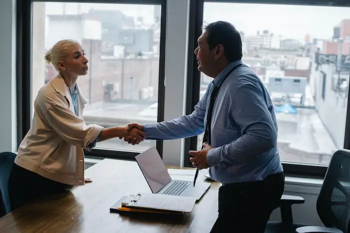 young_woman_shaking_hands_with_boss_after_business_hiring.jpg